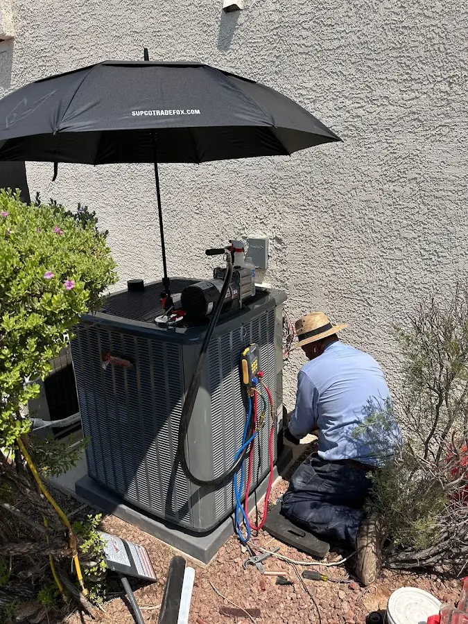 HVAC technician performing outdoor AC maintenance in Bellaire